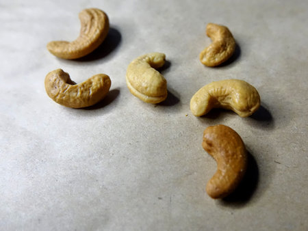 Cashew nuts on craft paper closeup peeled dry seeds