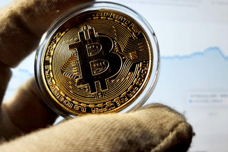 Bitcoin gold metal coin in capsule. Cryptocurrency symbol