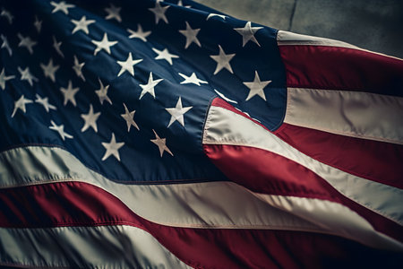 The cloth of the star-stripped American Flag of the United States with embroidered stars fluttering in the windの素材