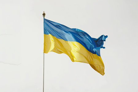 The Ukrainian flag, with its vibrant blue and yellow colors, waves gracefully against a bright white background. This striking display symbolizes national pride and resilience, capturing the essence of Ukraine's identity. The colors represent the sky and fields of wheat, reflecting the beauty of the nation.の素材