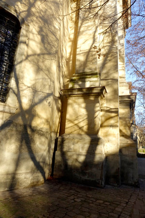 The sunlight creates intricate shadows on the foundation of the medieval Dominican cathedral in Lviv, revealing architectural details.の写真素材