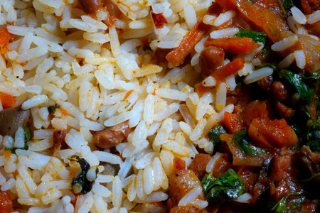 A delicious bowl of rice is accompanied by a vibrant vegetable stew, showing various colors and textures on a dining table.の写真素材