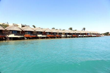 El Gouna, Egypt - July 09, 2017 - Bungalows Under Thatched Roofs Lining the Tranquil Waters of El Gouna Red Sea Egyptのeditorial素材