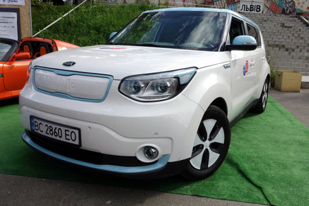 Lviv, Ukraine - June 6, 2017 KIA Soul EV At a community event, an electric vehicle parked on green grass draws attention with its modern design and eco-friendly featuresのeditorial素材