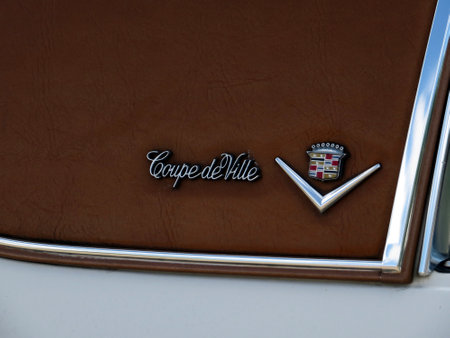 Lviv, Ukraine - June 5, 2016 The emblem of Cadillac Coupe de Ville highlights vintage charm and elegance, featuring intricate lettering and luxurious logo that emphasize classic automotive artistry.のeditorial素材