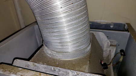 Detailed view of a corrugated pipe designed for gas ducting, connected to a domestic gas boiler system during installation. The setup ensures safe gas ventilation.の写真素材
