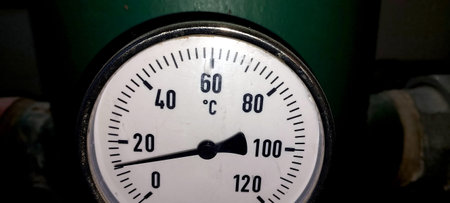 A temperature measurement instrument shows a dial indicating current temperature levels,...