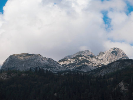 Durmitor mountains in Montenegro display their impressive peaks against a backdrop of fluffy clouds.の写真素材