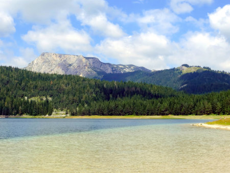 Black Lake in Durmitor National Park is a stunning natural destination in Montenegro. Clear waters reflect the majestic mountains and vibrant greenery.の写真素材
