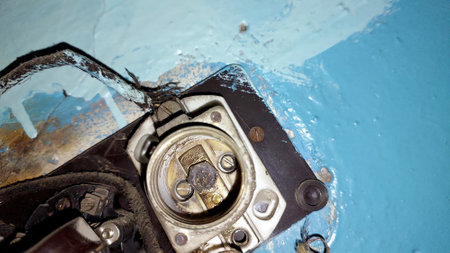 Vintage electrical fuses reveal signs of age and deterioration in a location with chipped paint. The setting shows textures of past use and historical elements.の写真素材