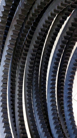 Multiple toothed V belts are arranged neatly, demonstrating their design and functionality for effective driving in various machinery applications.の写真素材