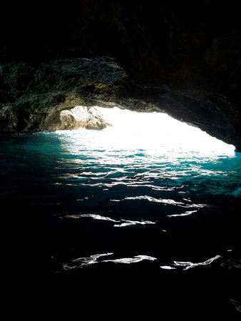 Visitors can marvel at the stunning blue grotto in Montenegro, where sunlight penetrates the rocky cave, illuminating the sparkling waters of the Adriatic Sea.の写真素材