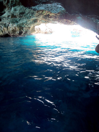 Visitors can marvel at the stunning azure waters illuminating the Blue Grotto in Montenegro, a hidden gem along the Adriatic Sea, ideal for exploration and relaxation.の写真素材