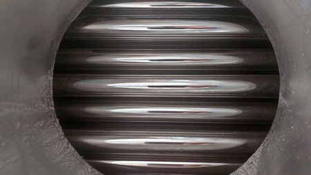 Close-up view of steel heat exchanger tubes with internal fins designed to improve thermal efficiency. This setup is vital for various industrial applications.の写真素材