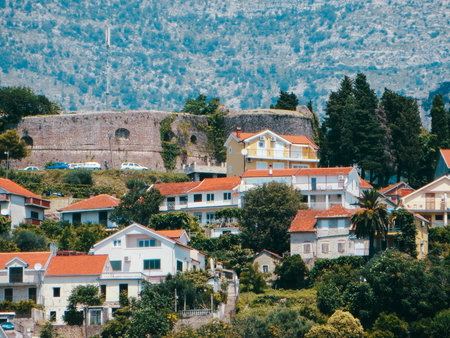 Herceg Novi showcases its historical fortresses and picturesque houses, framed by the stunning natural landscape of Montenegros Bay of Kotor on a sunny day.の写真素材