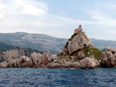 Visitors enjoy the breathtaking views of Sveta Nedjelja Church perched on a rocky outcrop in Katic Nature Park, Montenegro.の写真素材