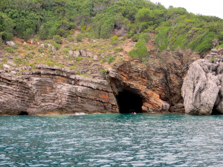 The rugged cliffs of Sveti Nikola island rise above the tranquil Adriatic Sea, showcasing natural rock formations and crystal-clear waters, ideal for exploration.の写真素材