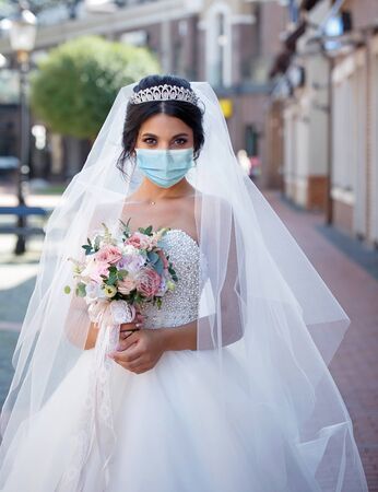 Bride medical mask getting. Coronavirus. wedding . Woman faceの写真素材