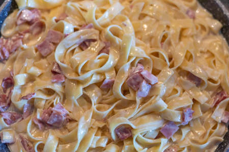 Fettuccine with ham and cream sauceの写真素材