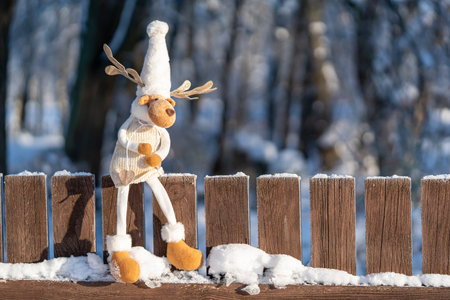 Figure of chrismas deer on fence. Concept of funny winter day and Christmas spirit.の写真素材