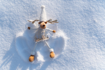 Figure of chrismas deer on snowy field. Concept of funny winter day and Christmas spirit.の写真素材