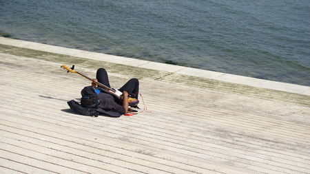 Guitarist playing on the beachの写真素材