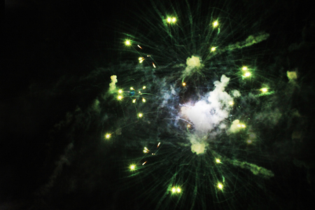 Beautiful fireworks in the night sky. A bouquet of green lights. Celebrating Merry Christmas and New Yearの写真素材
