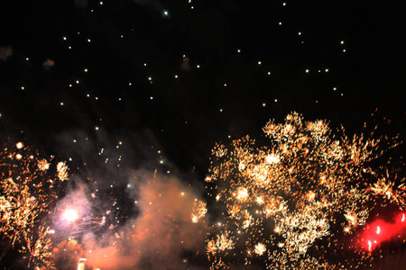 Fireworks. Firework. Heavenly background. Colorful wave of bright yellow sparkling lights in the...