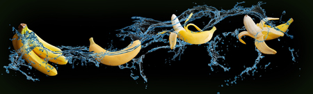 delicious fruit - bananas in water on an isolated green and black backgroundの写真素材