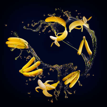 Juicy tasty banana with splashes of juice is full of vitaminsの写真素材