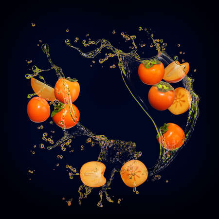 Juicy delicious persimmon with bursts of juice is very healthyの写真素材