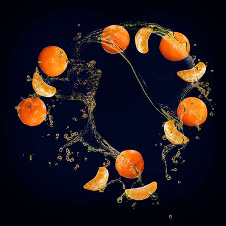 Juicy tasty tangerine with splashes of juiceの写真素材