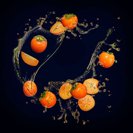 Juicy delicious persimmon with bursts of juiceの写真素材
