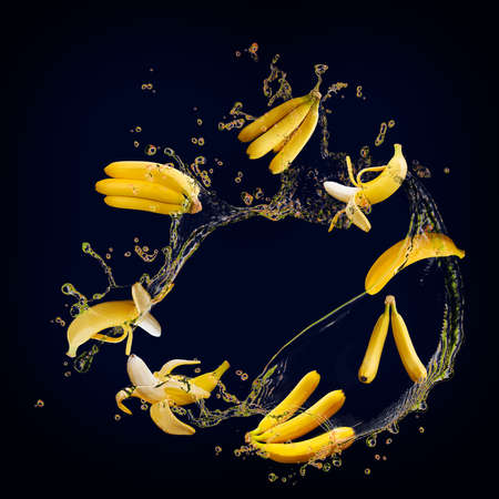 Juicy tasty banana with splashes of juiceの写真素材