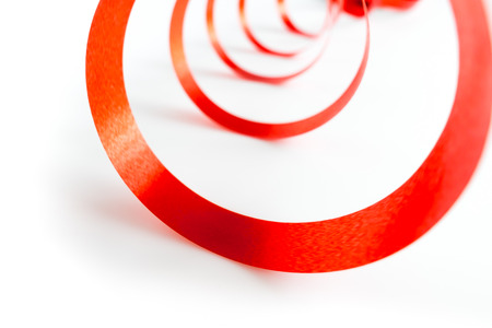 Shiny red ribbon with soft shadow on white backgroundの写真素材