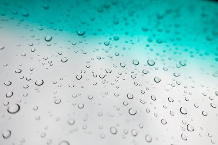 Water drops background. Water drops on glass window over blue sky.