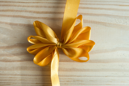 Ribbon Bow on wood backgroundの写真素材