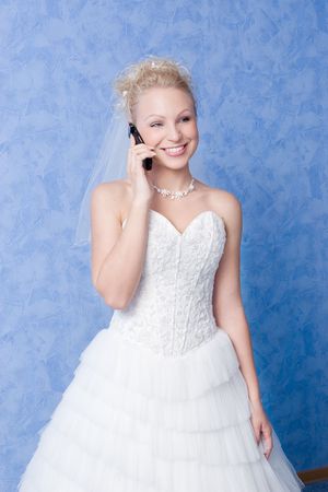 smiling bride calling by phoneの写真素材
