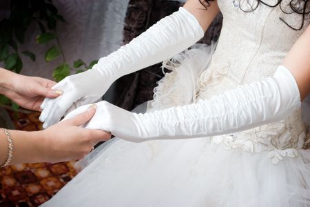 white gloves on the hands of the brideの写真素材