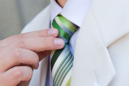 man puts on a necktieの写真素材