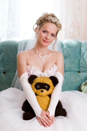 blond smiling bride with her favourite toyの写真素材