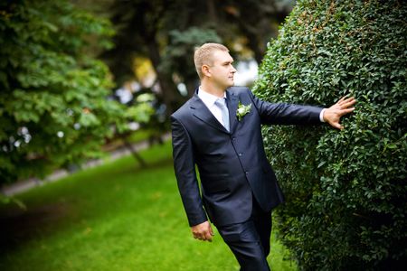 a happy groom walking outdoorsの写真素材