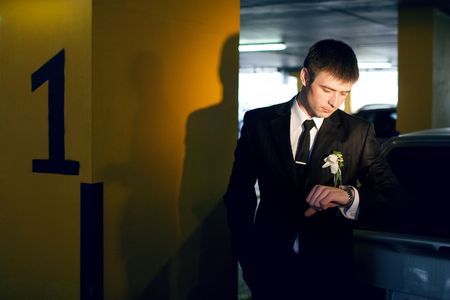 a groom with watch indoorsの写真素材