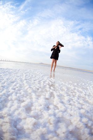 girl in a salt lake in a sunriseの写真素材