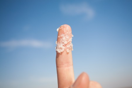 big salt crystals on the fingerの写真素材