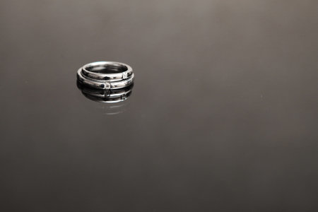 wedding rings on the glass table in black and whiteの写真素材