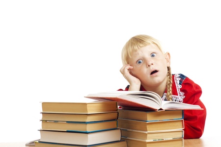 tired small girl with many booksの写真素材