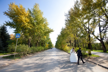 bride and groom crossing the roadの写真素材