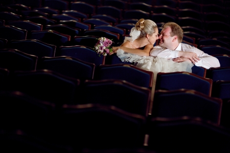bride and groom at the theatre kissingの写真素材