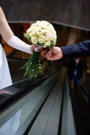 wedding bouquet in hands of the bride and groomの写真素材